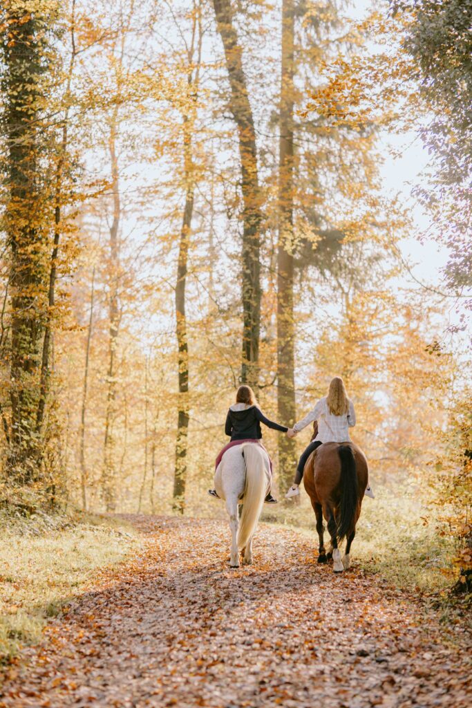 cowgirls riding horses